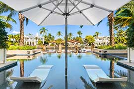 sunbeds insatlled in a swimming pool facing the garden